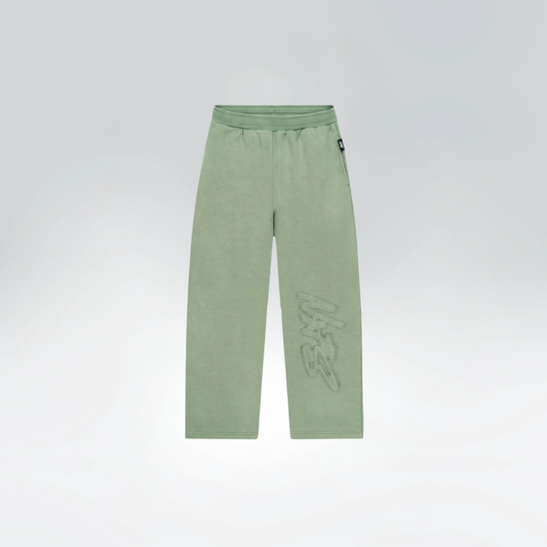 Green pants with a brand logo on a light gray background