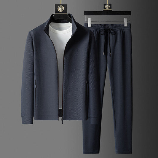 Navy tracksuit with jacket and pants on a gray background