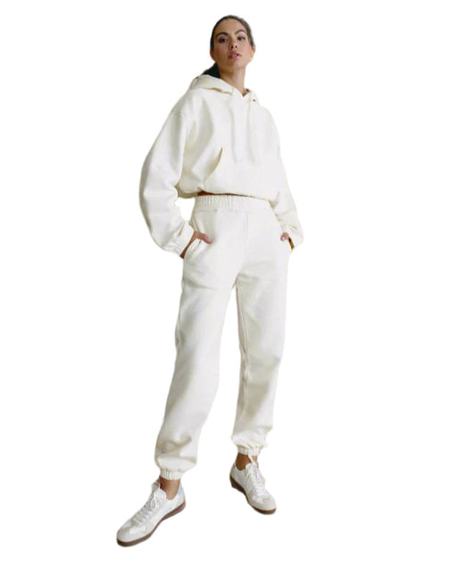 Person wearing a white tracksuit on a white background