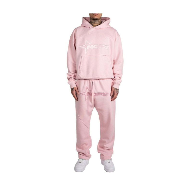 Person wearing a pink tracksuit on a white background