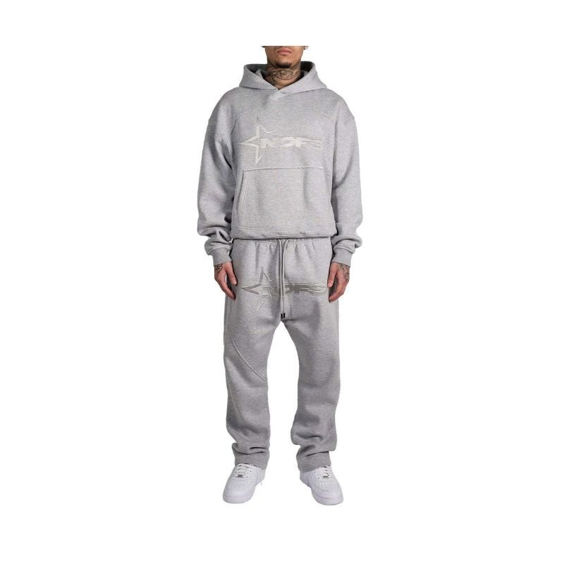 Person wearing a gray tracksuit with a logo on a white background