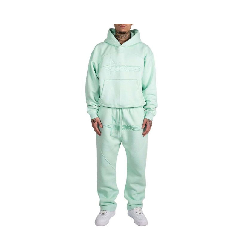 Person wearing a light green tracksuit on a white background