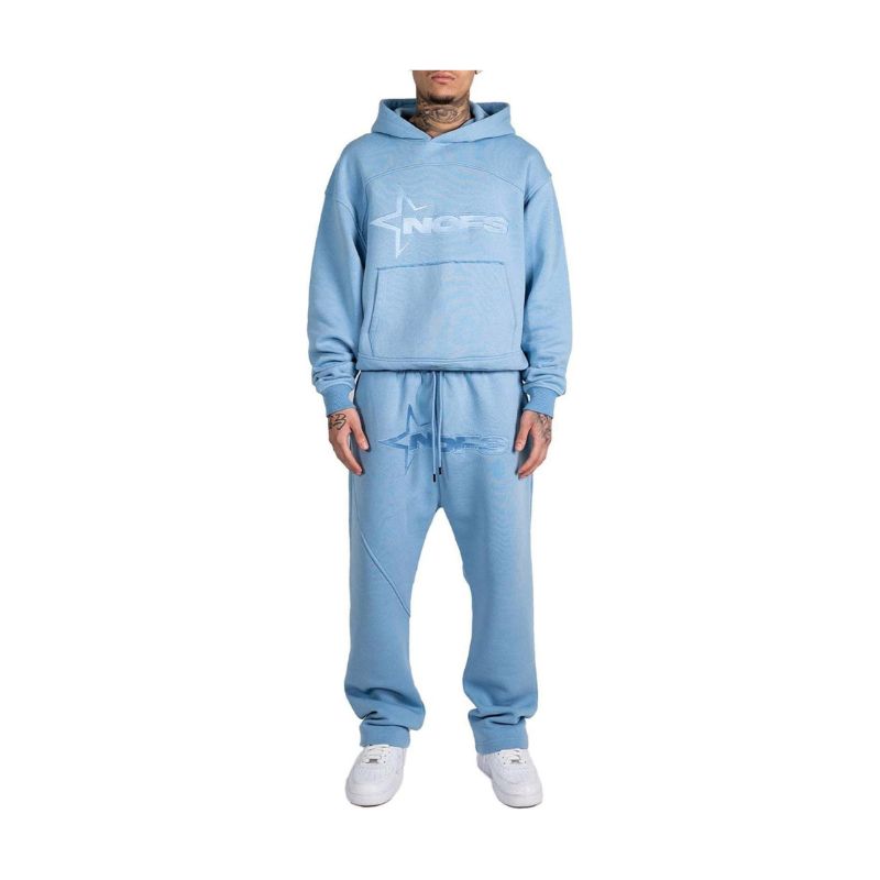 Light blue tracksuit worn by a person on a white background