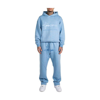 Light blue tracksuit worn by a person on a white background