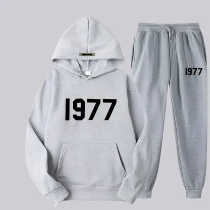 Gray hoodie and jogger pants set with '1977' text on a light gray background