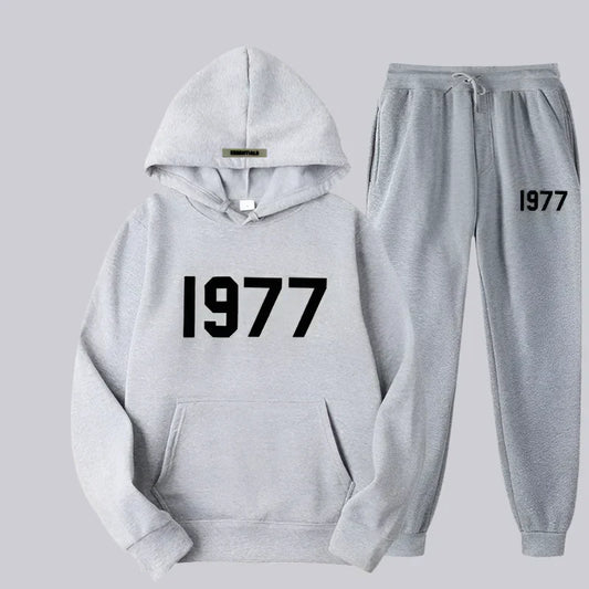 Gray hoodie and jogger pants set with '1977' text on a light gray background