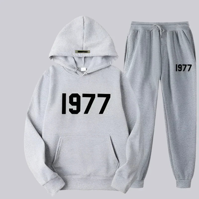 Gray hoodie and jogger pants set with '1977' text on a light gray background