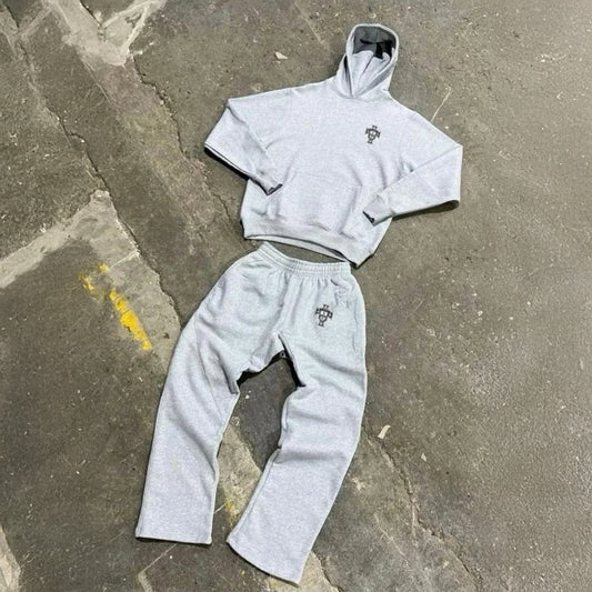 Gray hoodie and pants set on a concrete surface