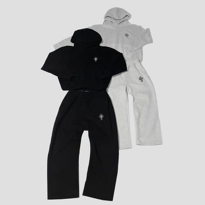 Black and gray tracksuits with a brand logo on a light gray background