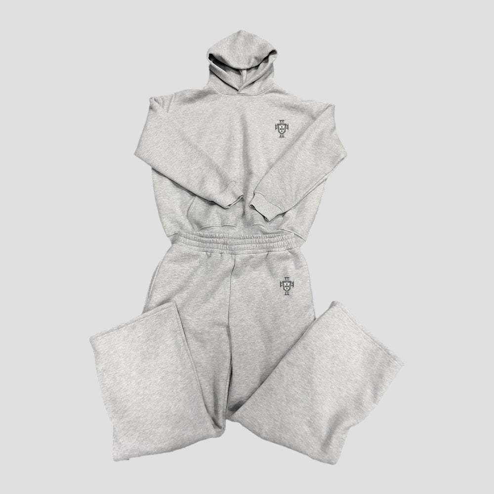 Gray tracksuit with a logo on a light gray background