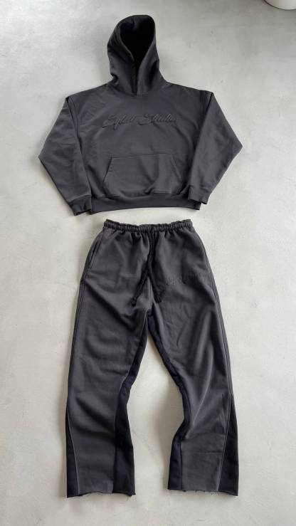 Gray hoodie and pants set on a light gray background