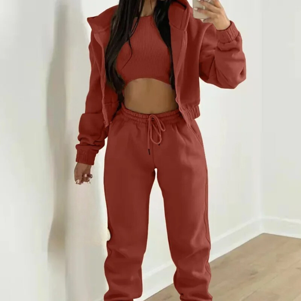 Person wearing a red tracksuit against a white background