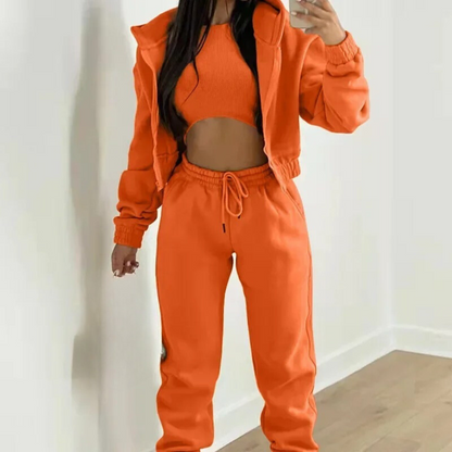 Person wearing an orange tracksuit against a white background