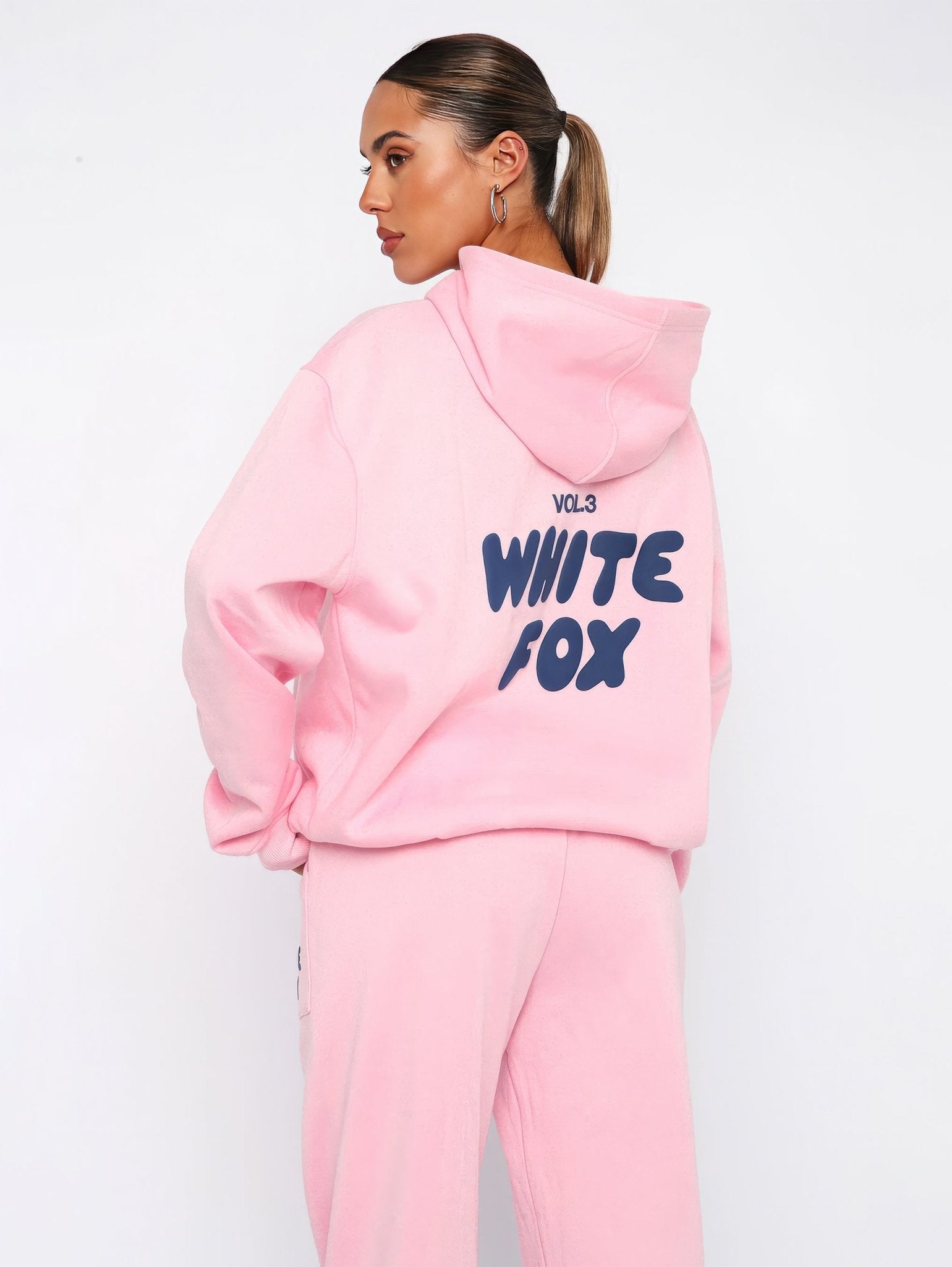 Person wearing a pink hoodie with 'White Fox' text on a white background