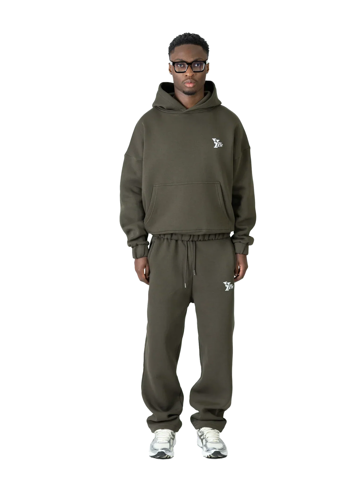 Person wearing a green tracksuit with a brand logo on a white background