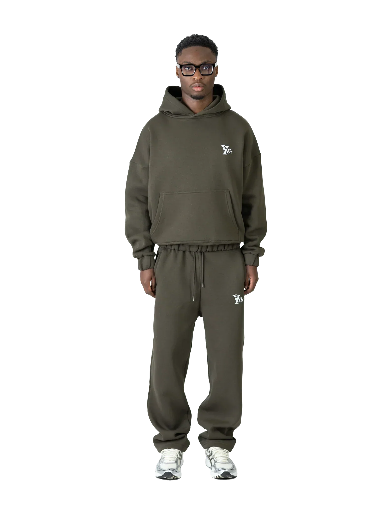 Person wearing a green tracksuit with a brand logo on a white background