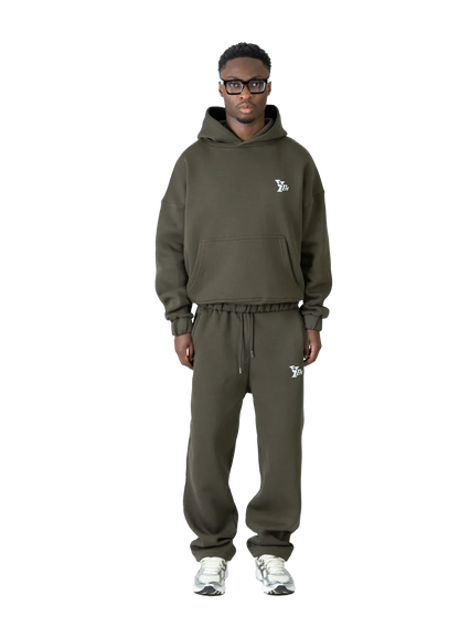 Person wearing a green tracksuit with a brand logo on a white background