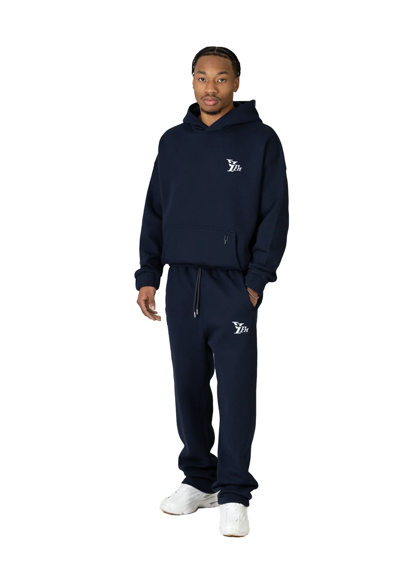 Person wearing a navy tracksuit with a logo on a white background