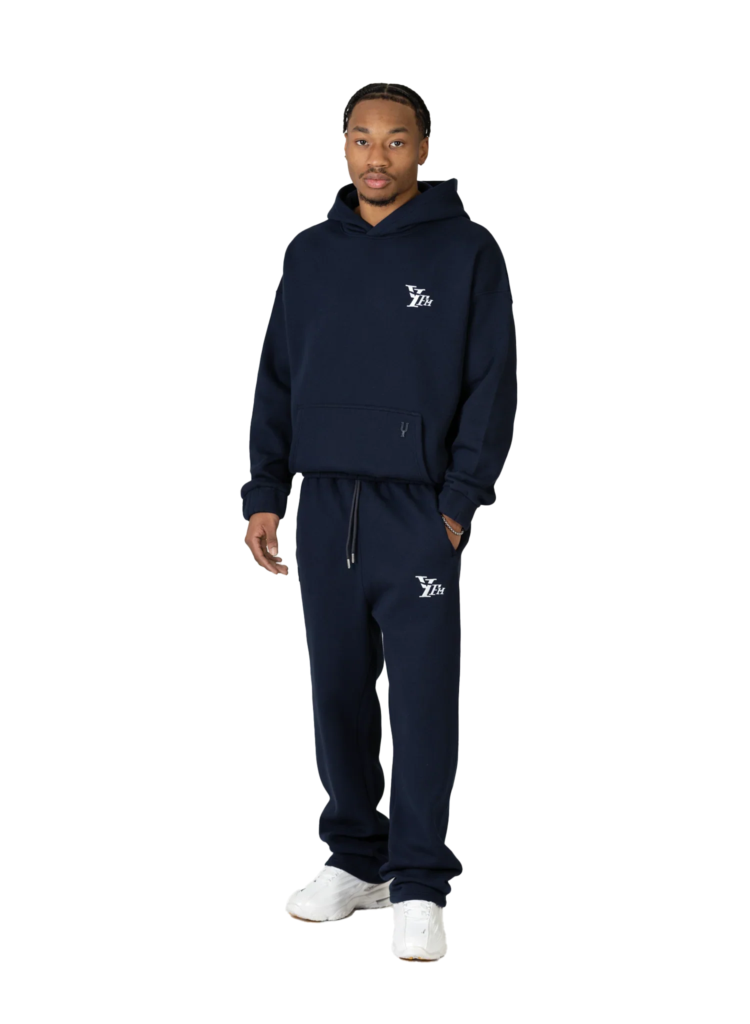 Person wearing a navy tracksuit with a logo on a white background
