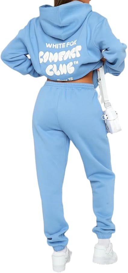 Light blue tracksuit with 'White Fox Comfort Club' text on the back, worn by a person.