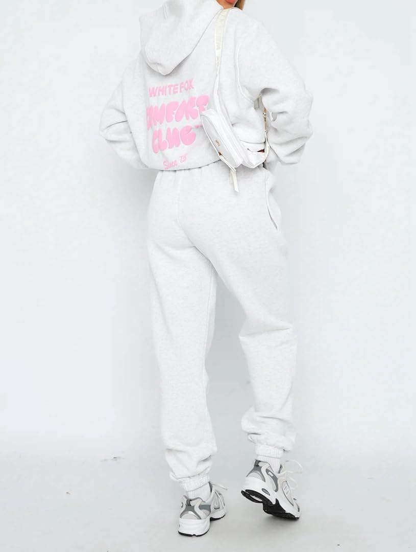 Person wearing a white hoodie and pants with pink text on a white background