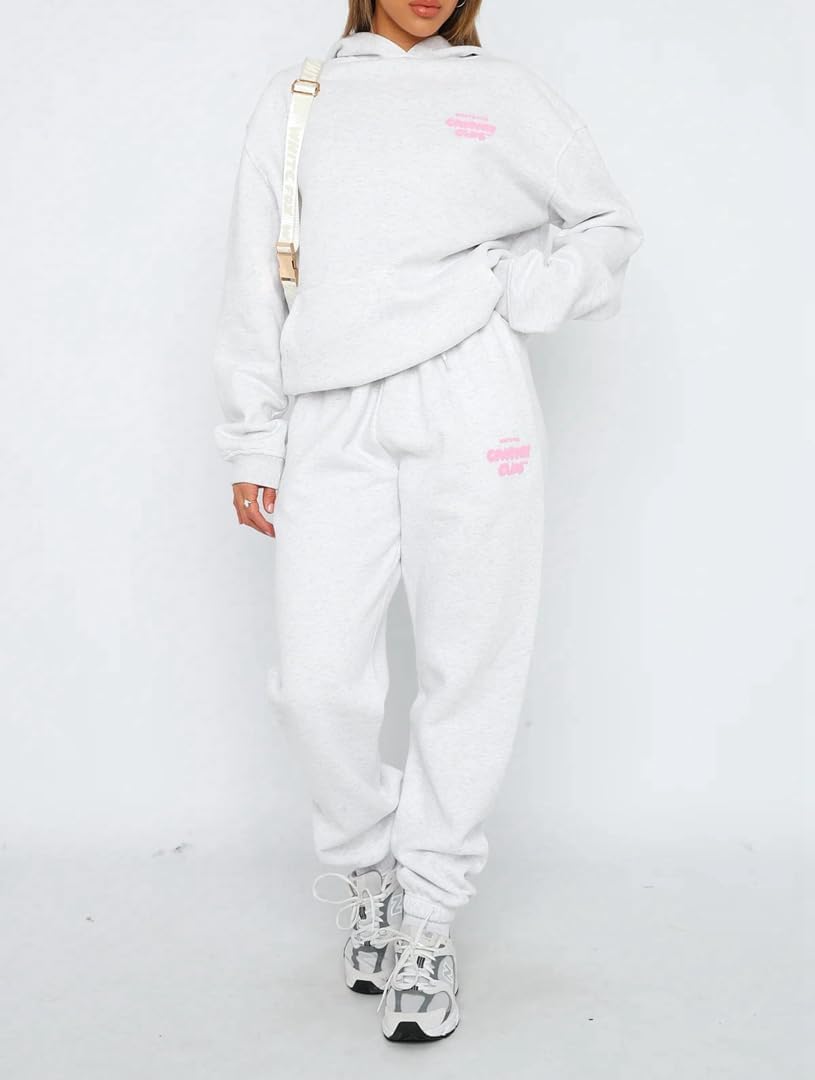 Person wearing a light gray tracksuit with pink text on a white background