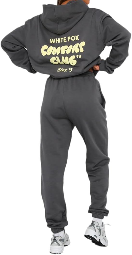 Person wearing a gray tracksuit with 'White Fox' branding on the back.