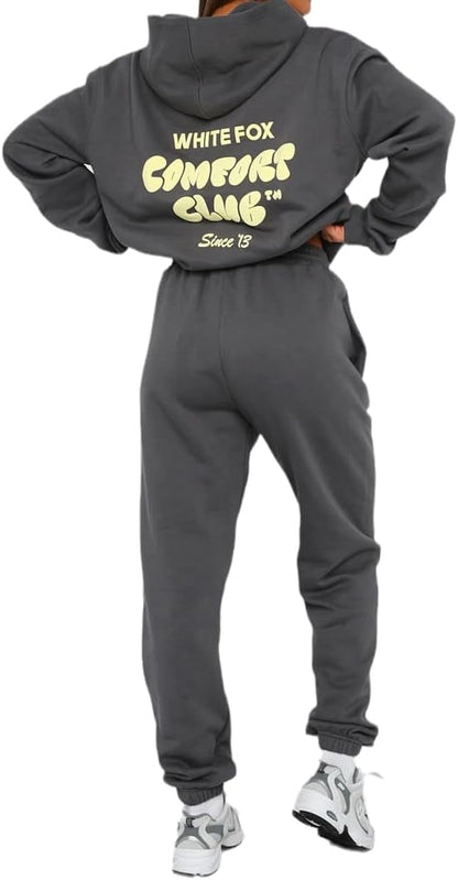 Person wearing a gray tracksuit with 'White Fox' branding on the back.