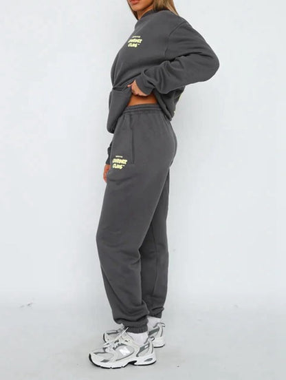 Person wearing a gray tracksuit with yellow text on a white background