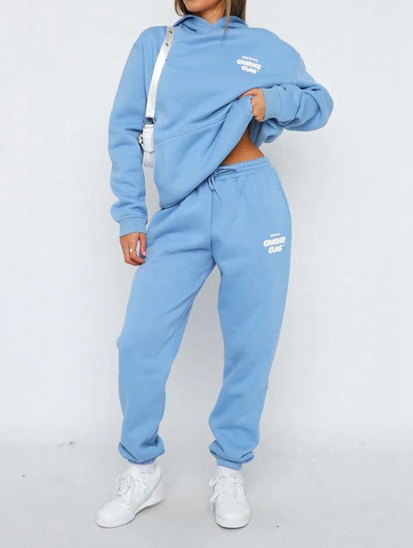 Person wearing a blue tracksuit with white branding on a white background