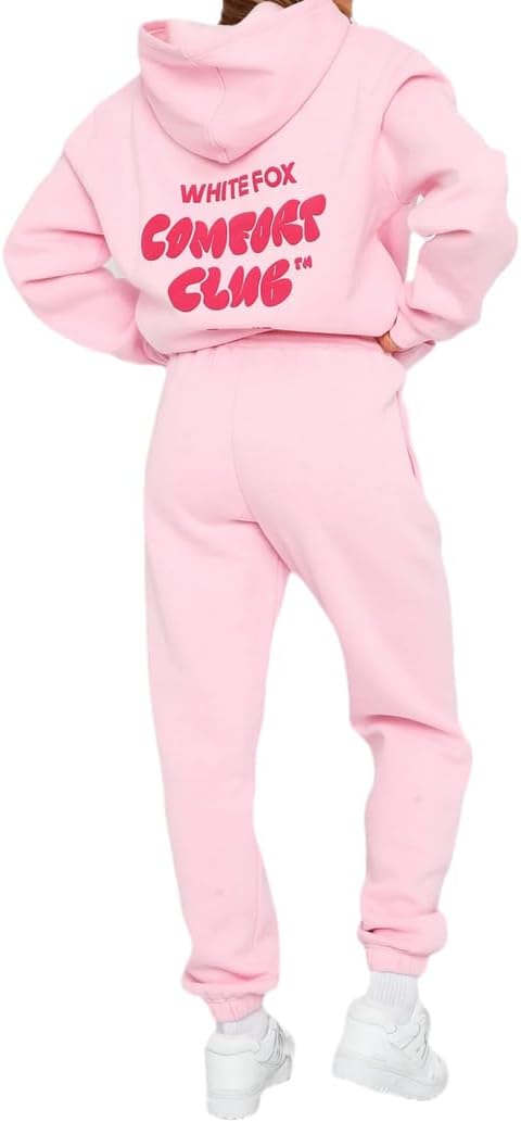 Pink hoodie and jogger set with text on the back, worn by a person.