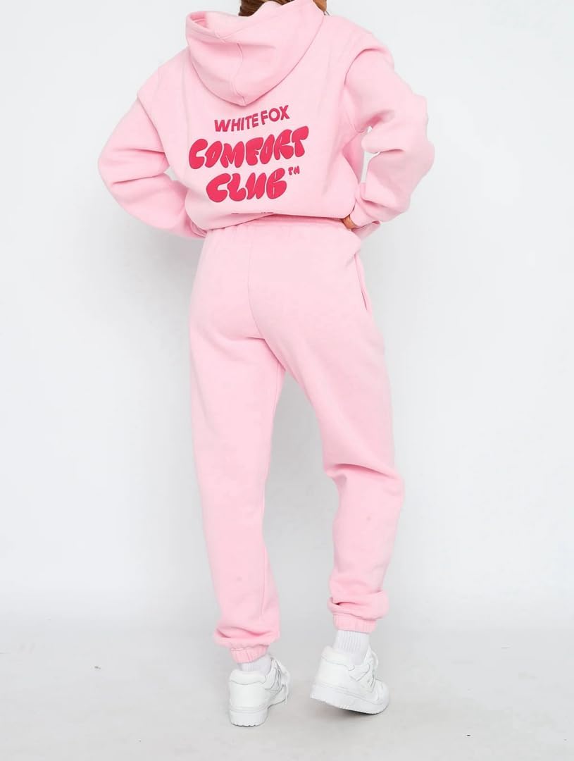 Pink hoodie and jogger set with 'White Fox Comedy Club' text on a white background