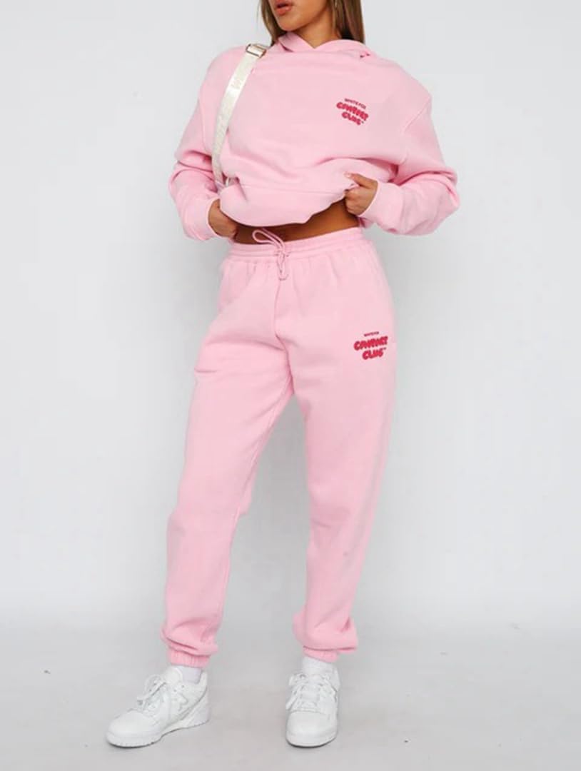Person wearing a pink tracksuit with branding on a white background
