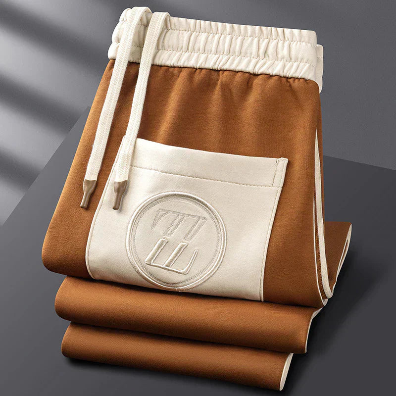 Brown and white drawstring bag with a logo on a gray background