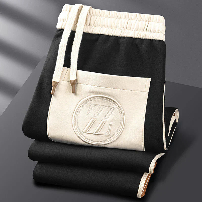 Black and white drawstring bag with a logo on a dark surface