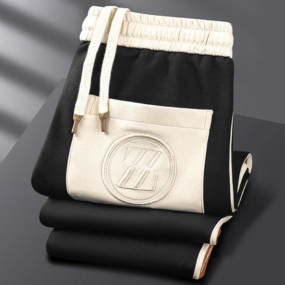 Black and white drawstring bag with a logo on a dark surface