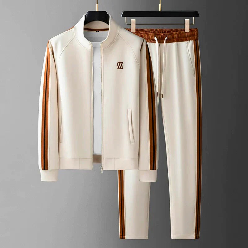 Beige tracksuit with brown stripes on hangers against a gray background