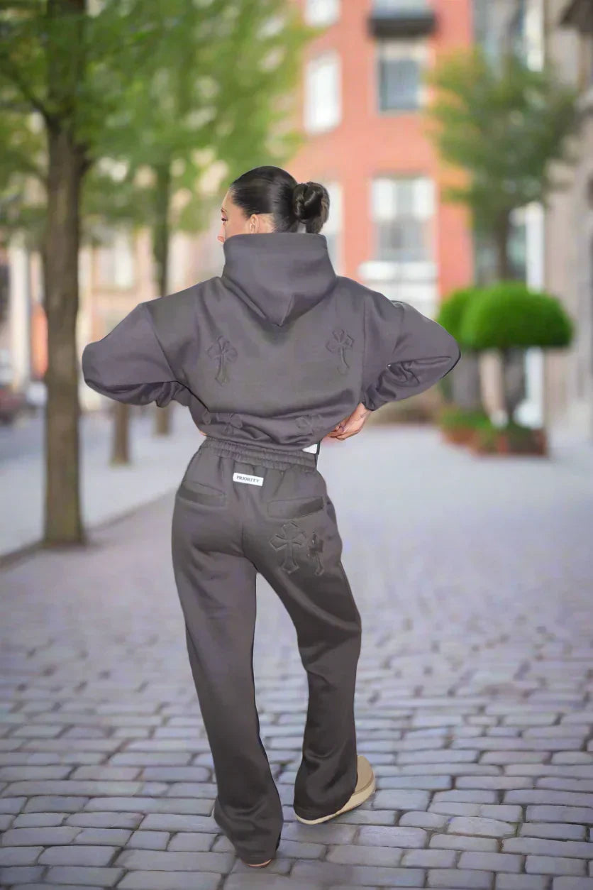 Person wearing a gray tracksuit on a city street