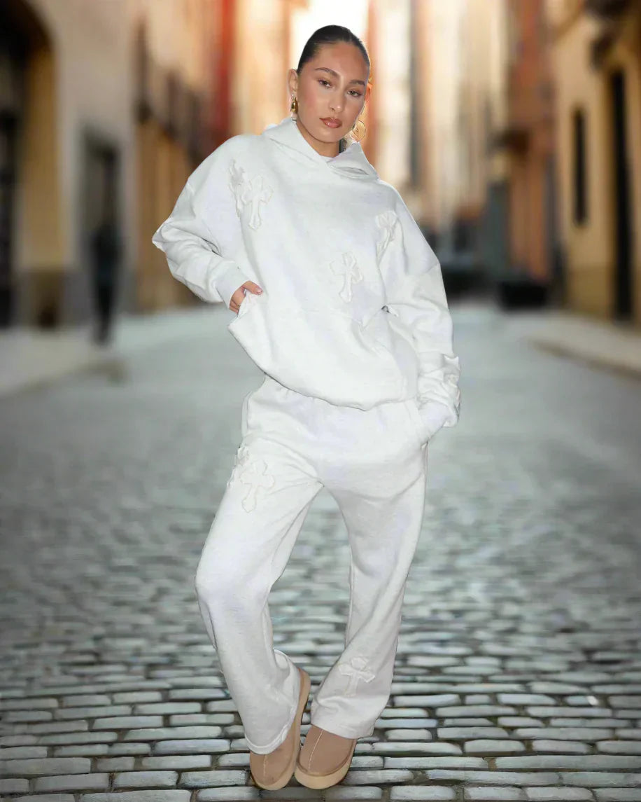Person wearing a white outfit on a cobblestone street